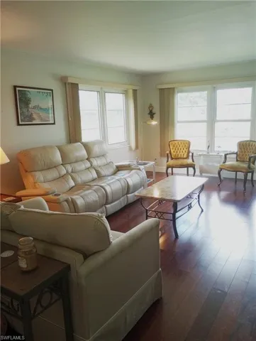 Living room to Windows overlooking pond, golf course and pool
