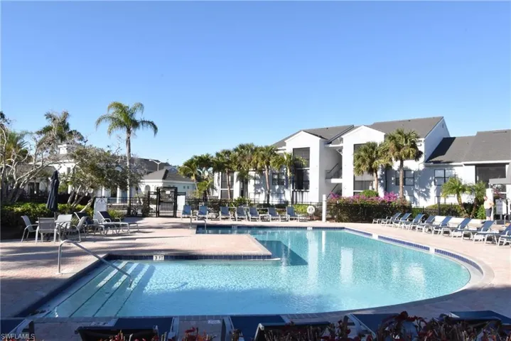Community pool with a patio