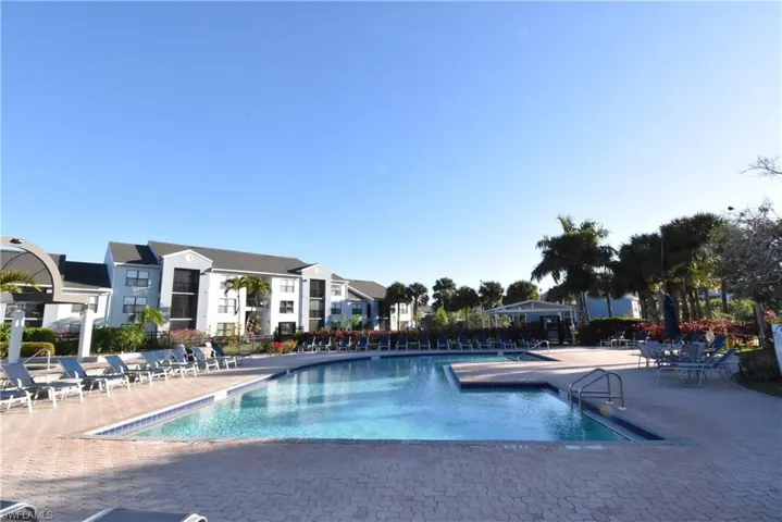 Community pool with a patio