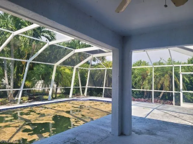 View of swimming pool featuring a patio, a lanai, and ceiling fan