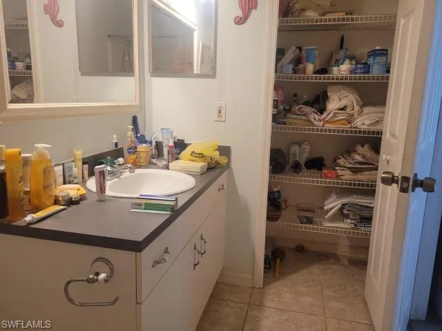 Bathroom featuring tile patterned flooring and vanity