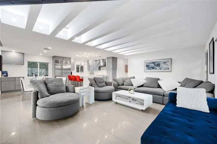 Open living room with grey tones and a splash of blue!