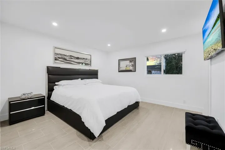 Spacious White and earth tone bedroom.