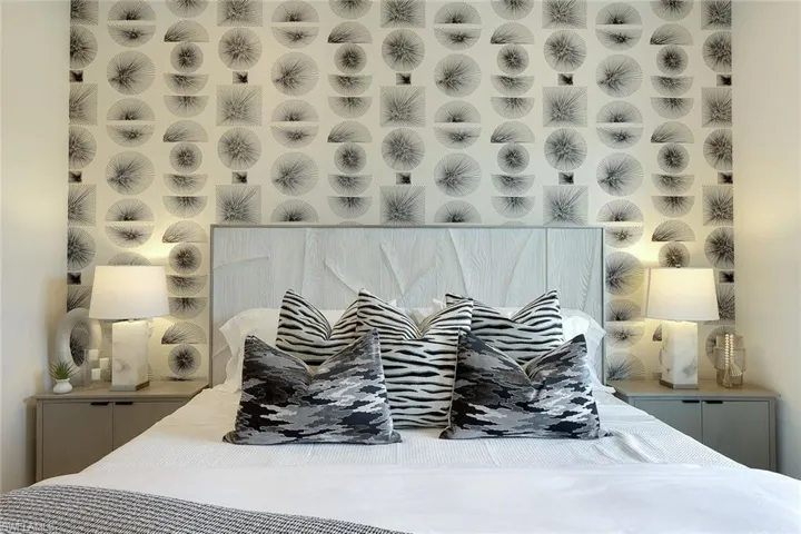 Bedroom featuring wallpapered walls
