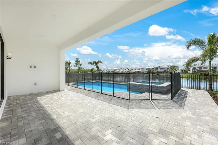 View of pool with a water view and a patio area