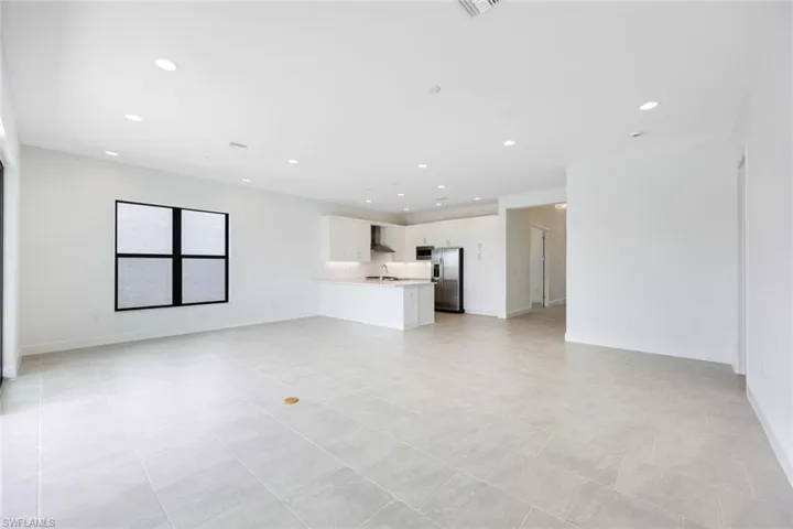 Unfurnished living room with light tile patterned floors