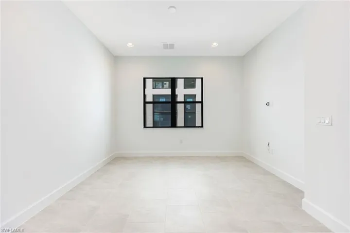 Empty room with light tile patterned floors