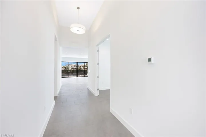 Corridor with light tile patterned flooring