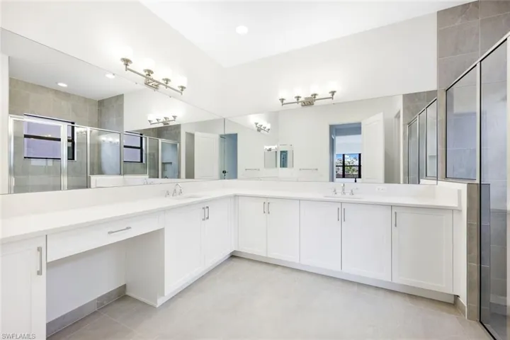 Bathroom featuring vanity, an enclosed shower, and tile patterned floors