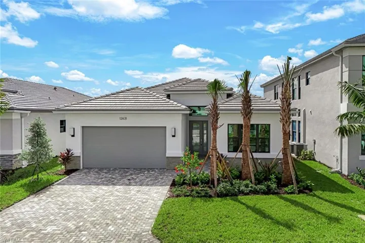 View of front of property with a front lawn and a garage