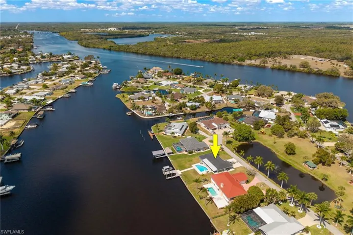 Aerial perspective of suburban area featuring a nearby body of water