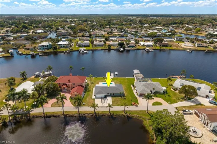 Aerial view of residential area featuring a nearby body of water