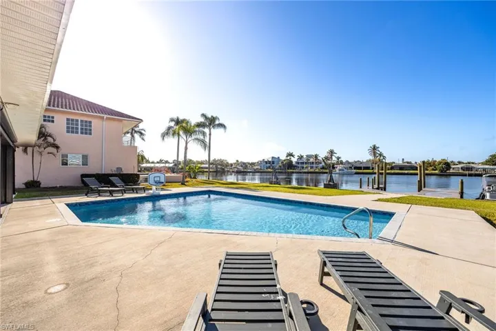 Outdoor pool featuring a patio and a water view