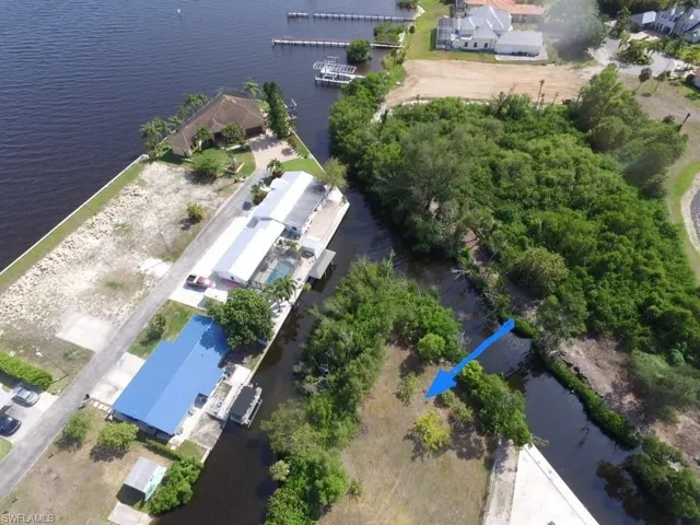 Aerial view of property and surrounding area featuring a nearby body of water