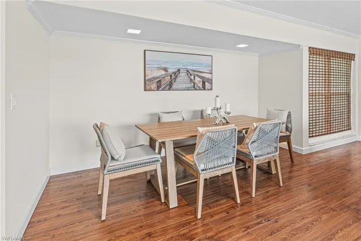 Dining room with crown molding and wood finished floors