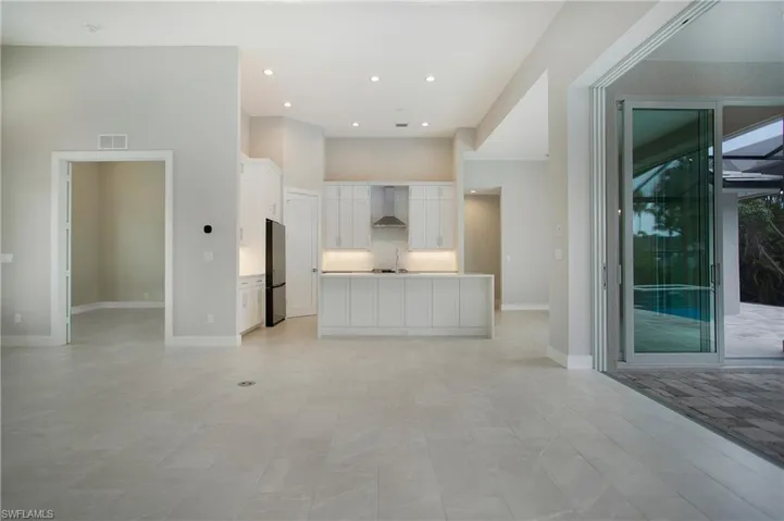 Unfurnished living room with a towering ceiling