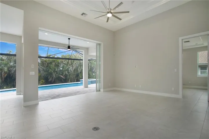 Tiled empty room featuring ceiling fan