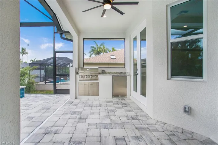 Unfurnished sunroom with ceiling fan