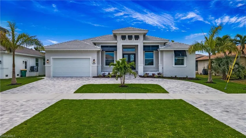 Prairie-style home with a garage and a front lawn