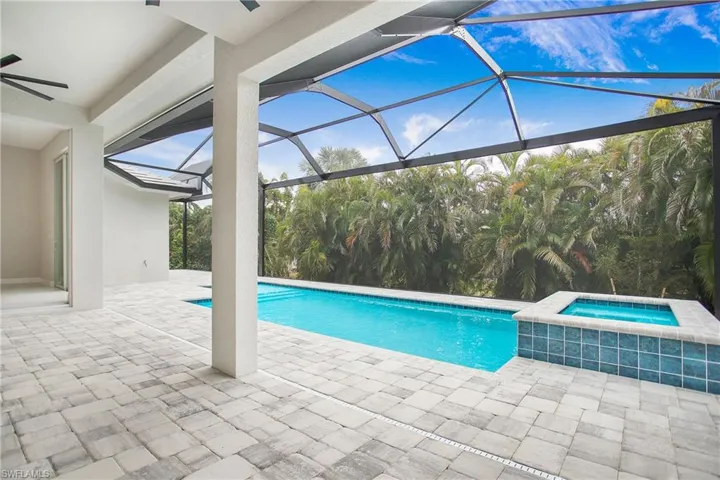 View of pool featuring a patio, a lanai, ceiling fan, and an in ground hot tub
