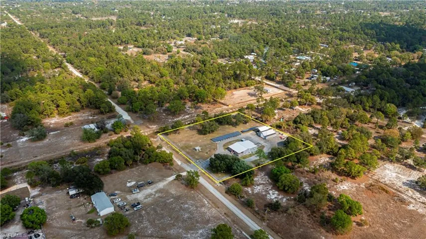 Aerial overview of property's location with property boundaries highlighted and a forest