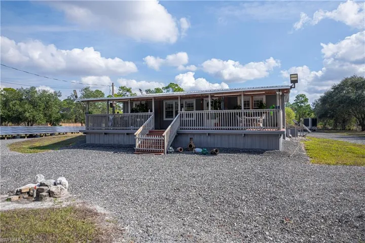 Manufactured with a metal roof and a porch.