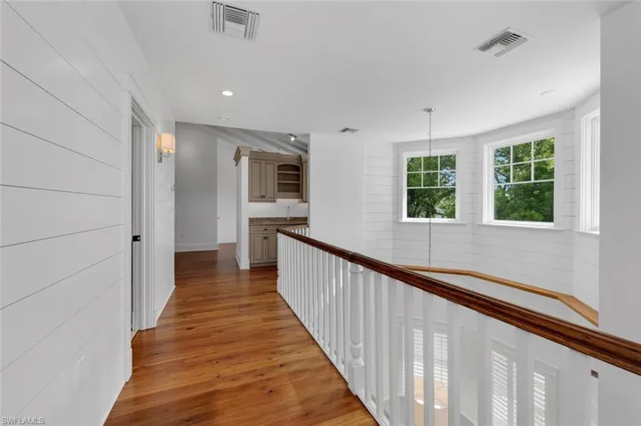 Corridor with light hardwood / wood-style flooring