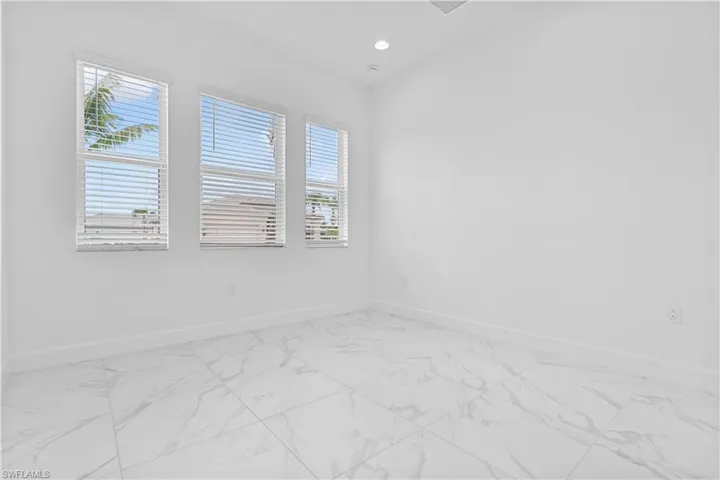 A bright and comfortable 2nd bedroom features elegant tile flooring and easy access to the adjacent second full bathroom.