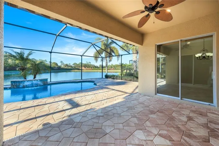 View of swimming pool , ceiling fan, pool water feature, a water view, and a patio