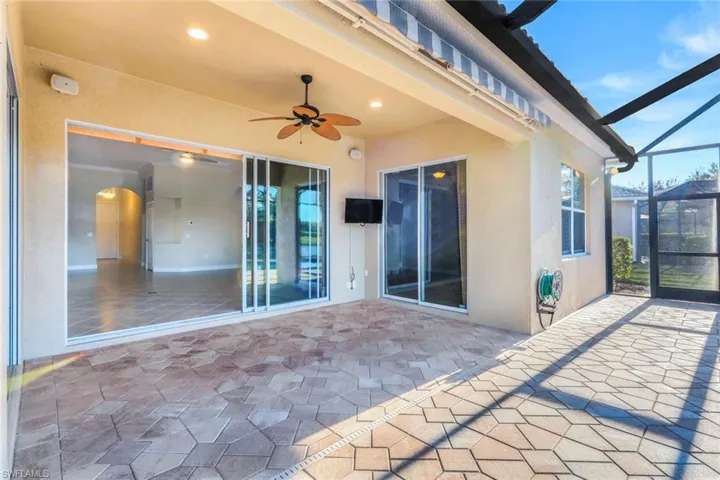 View of patio / terrace featuring ceiling fan and a lanai