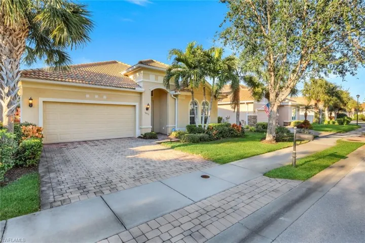 Mediterranean / spanish house with a garage and a front lawn