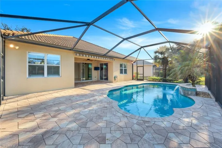 View of swimming pool featuring ceiling fan, a lanai, and a patio