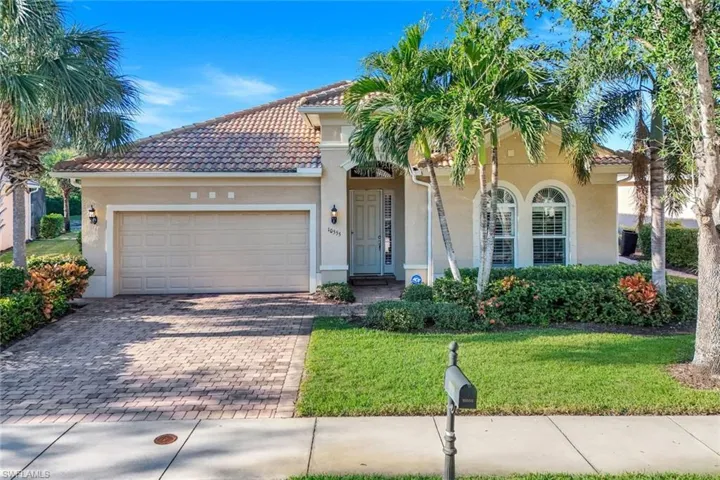 Mediterranean / spanish house with a front lawn and a garage