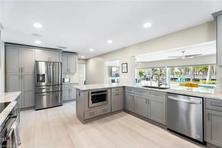 Stainless appliances, quartz countertops, custom cabinetry