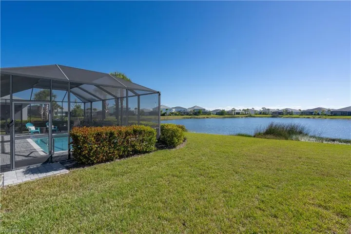 Screened-in pool enclosure featuring a paver deck