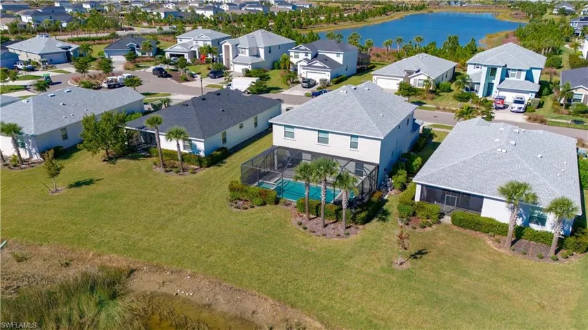 Aerial perspective showcasing a residential community with a central water body