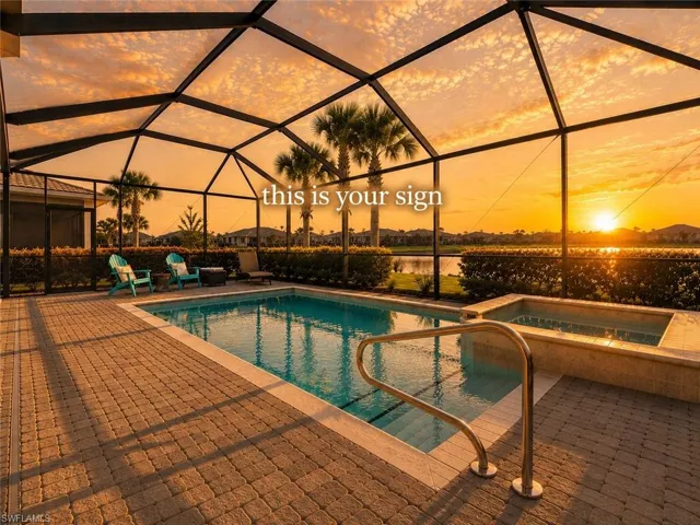 Screened-in outdoor living space featuring a swimming pool, integrated spa, and paver decking