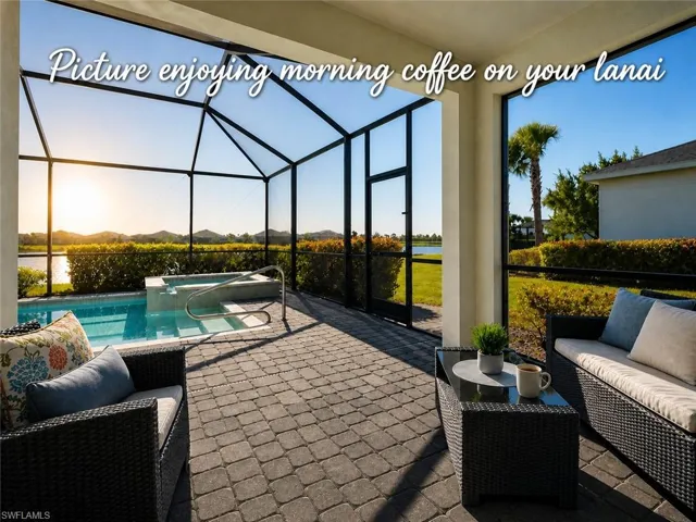Screened outdoor living area featuring a paver patio, a swimming pool with an integrated spa, and direct water access