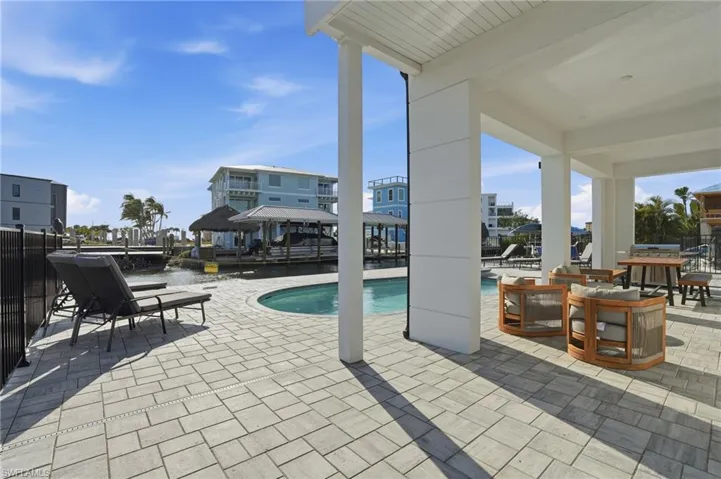 Outdoor pool featuring a patio and area for grilling