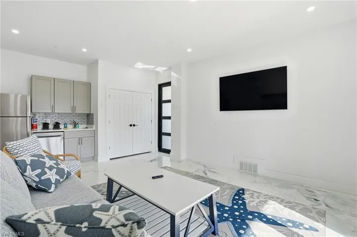Living room featuring recessed lighting and light Epoxy floors Virtually Edited