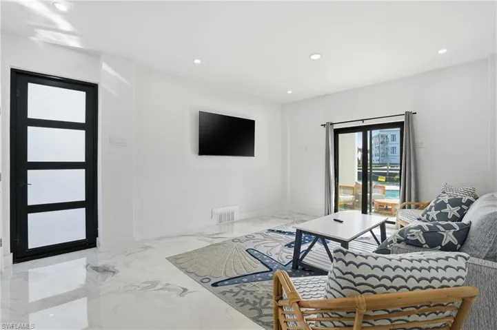 Living room featuring recessed lighting and Epoxy flooring Virtually Edited
