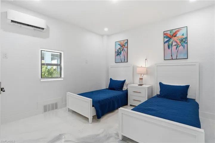 Bedroom with a wall unit AC virtually edited