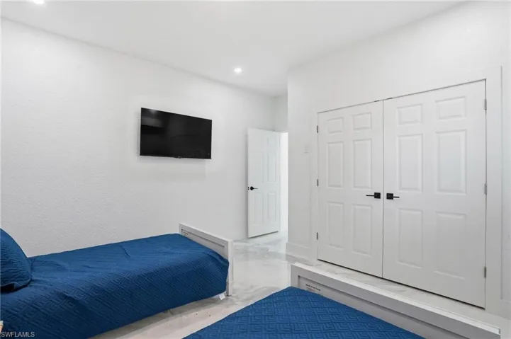 furnished bedroom featuring a closet and recessed lighting virtually edited