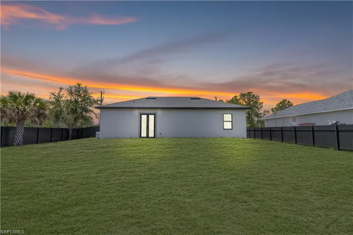 Back of property featuring stucco siding