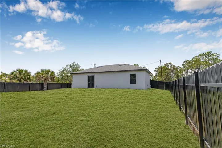 Back of house featuring stucco siding