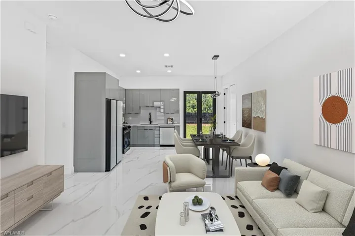 Living area with recessed lighting and light marble finish floors