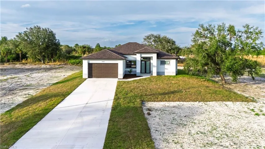 View of front of house featuring a front yard and a garage