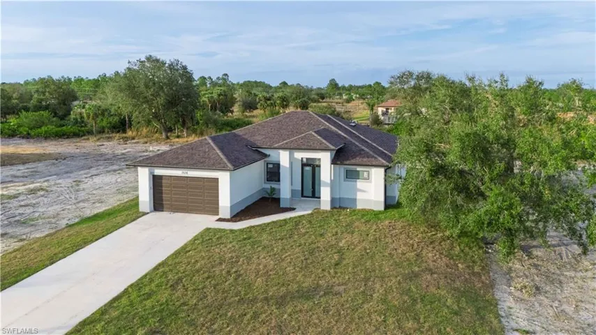 View of front of home featuring a front yard and a garage