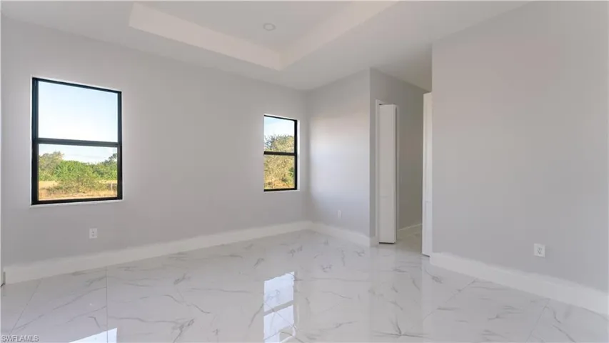 Spare room featuring a tray ceiling