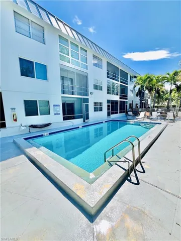 Community pool featuring a patio